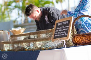 A restaurant server prepares food for guests at Party on the Pass