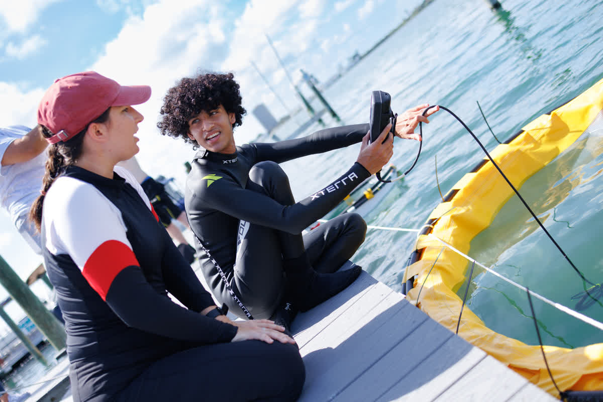 Mote's Jess Frankle with an intern monitoring the conditions inside a limnocorral (a cylindrical large structure with thick material to block a certain portion of the water column for a red tide mitigation experiment.