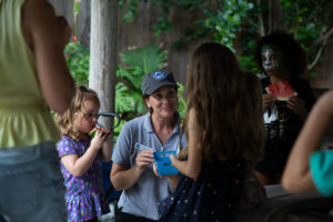 Children learn about sharks while making a shark tooth necklace.