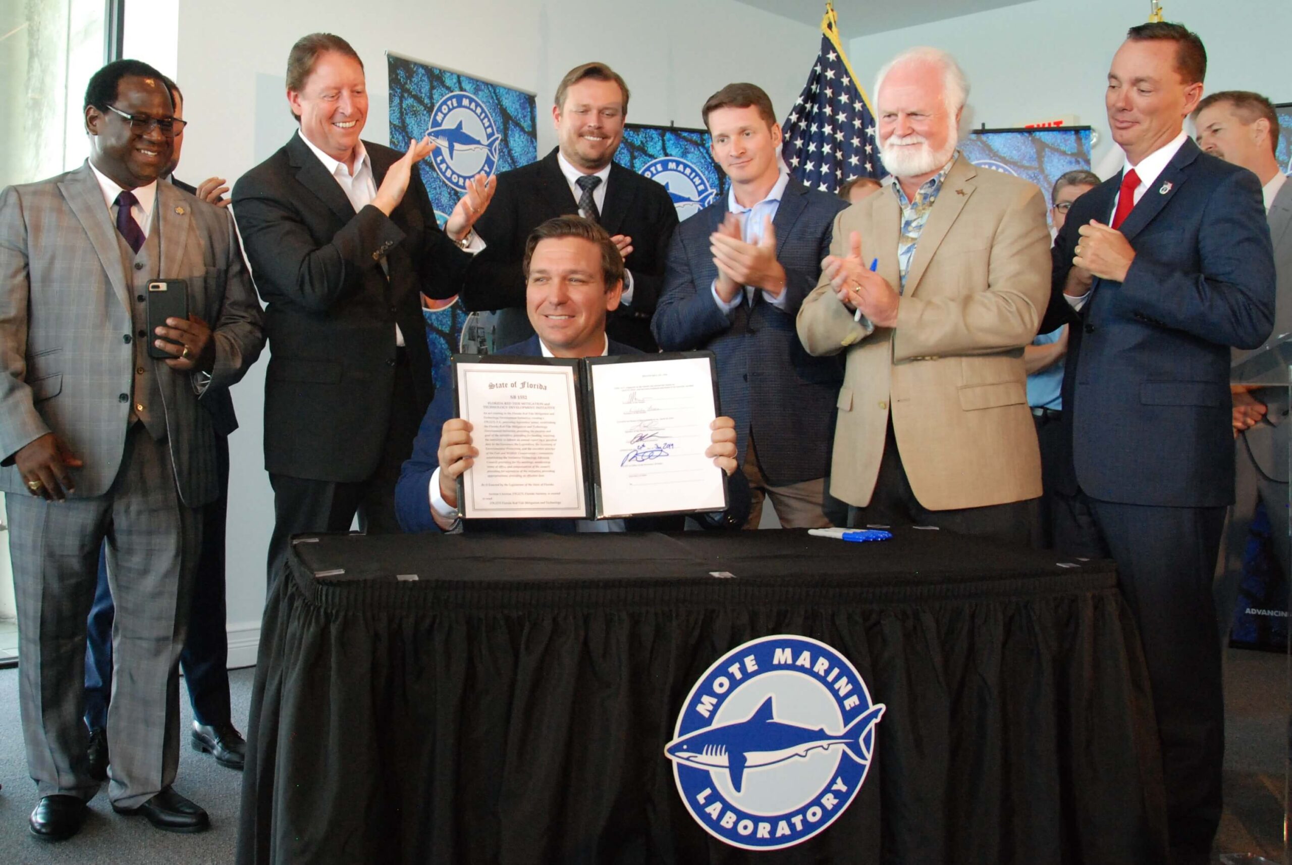Florida Governor Ron DeSantis signs Senate Bill No. 1552 to establish and support the Florida Red Tide Mitigation & Technology Development Initiative in June 2019 at Mote Marine Laboratory.